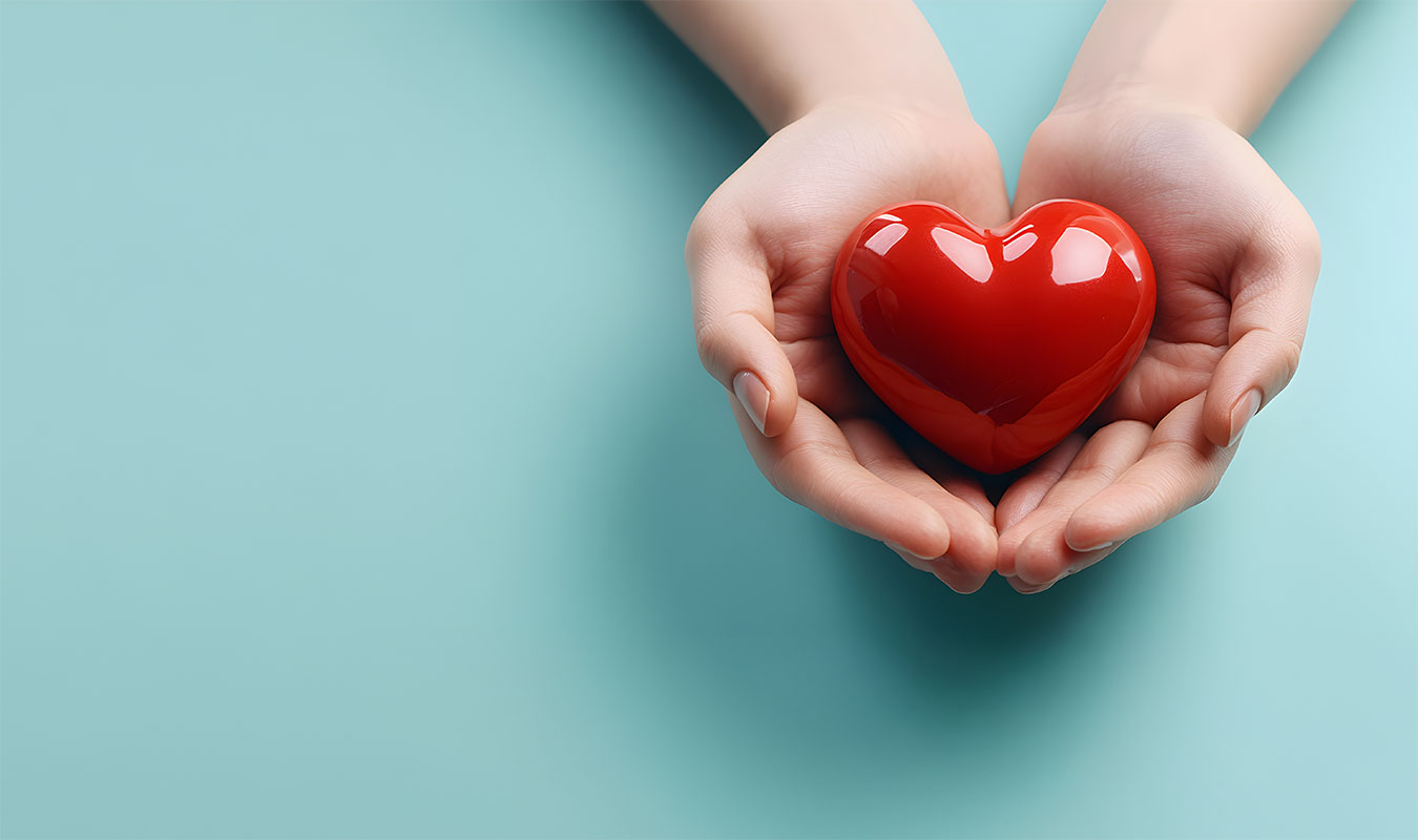 Woman hands holding red heart isolated on light blue background with copy space. Healthcare, medicine and wellness concept. High quality photo. Valentine's day.
