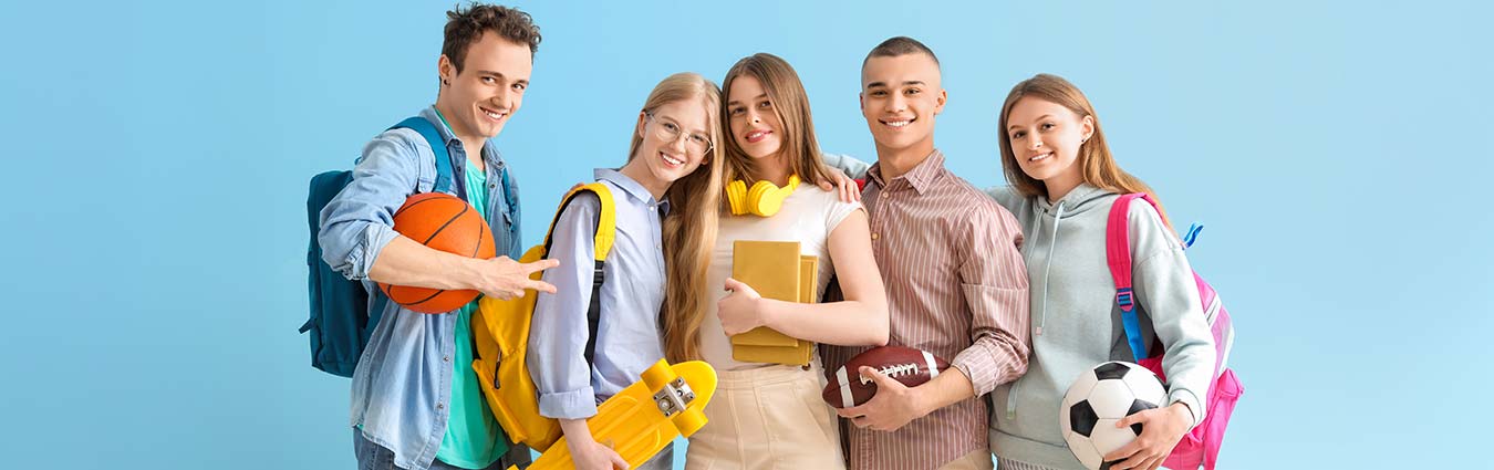 Group of students with backpacks and sport equipment on blue background